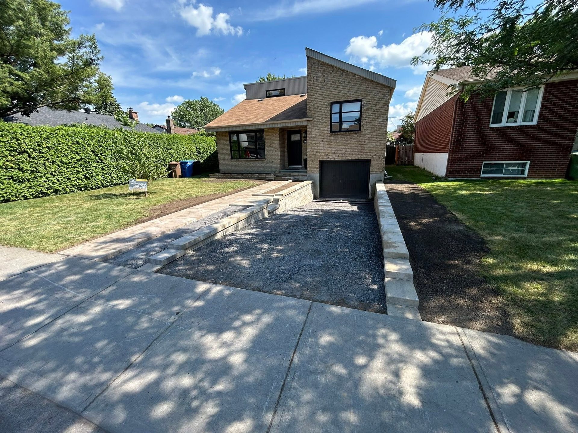 Paver edging along a prepared driveway before asphalt is laid